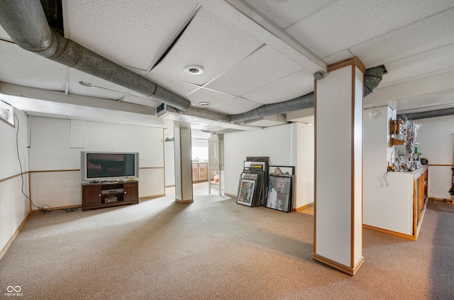 basement with carpet flooring and a drop ceiling