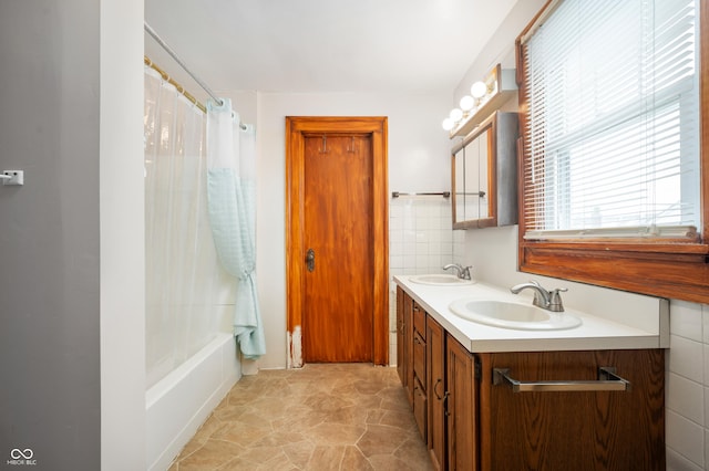 bathroom featuring vanity, tile walls, and shower / bath combo with shower curtain