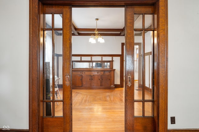 entryway with a chandelier