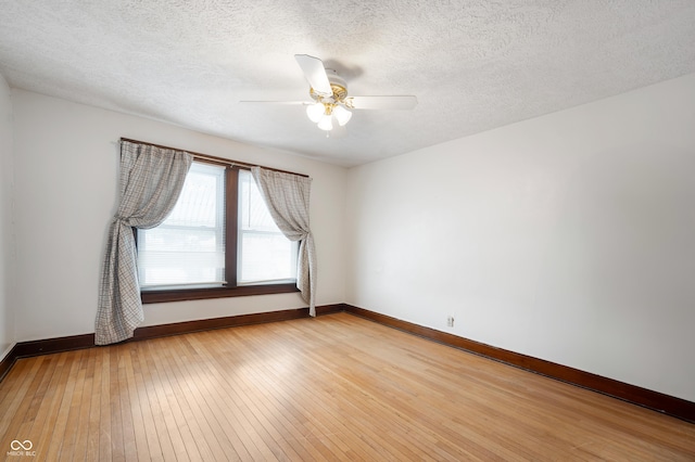 spare room with ceiling fan, light hardwood / wood-style floors, and a textured ceiling