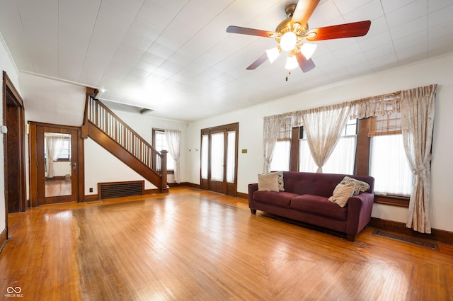 unfurnished living room featuring light wood-type flooring and ceiling fan