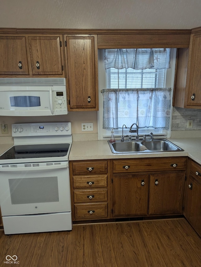 kitchen featuring sink, white appliances, and dark wood-type flooring