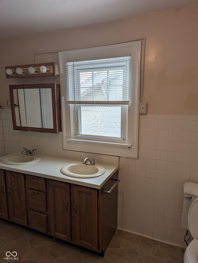 bathroom featuring tile walls, vanity, and tile patterned flooring