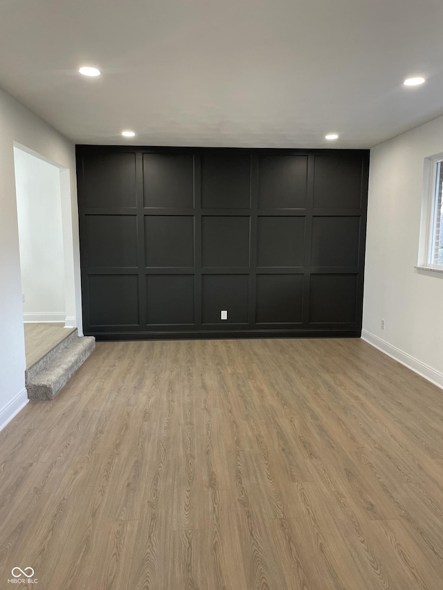 empty room with light hardwood / wood-style flooring