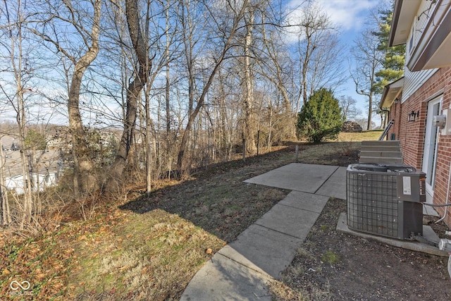 view of yard featuring a patio and central AC