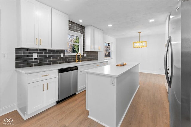 kitchen with white cabinets, appliances with stainless steel finishes, and a kitchen island