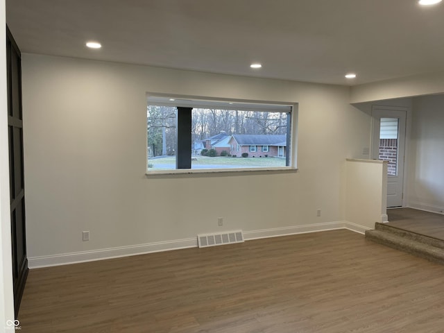 unfurnished living room with dark hardwood / wood-style floors