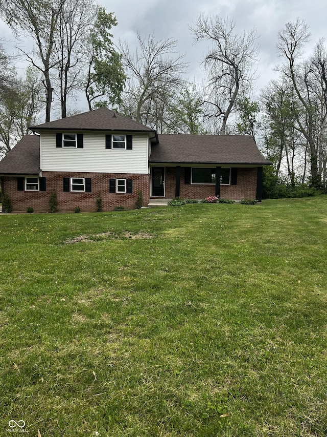454 Tulip Dr, Mooresville, IN 46158 - split level home featuring a shingled roof, a front lawn, and brick siding