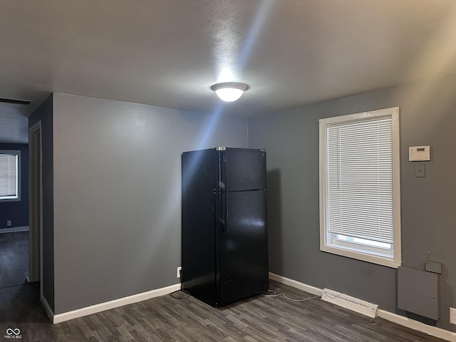 kitchen featuring black refrigerator and dark wood-type flooring