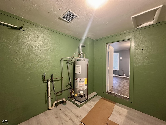 utility room featuring water heater