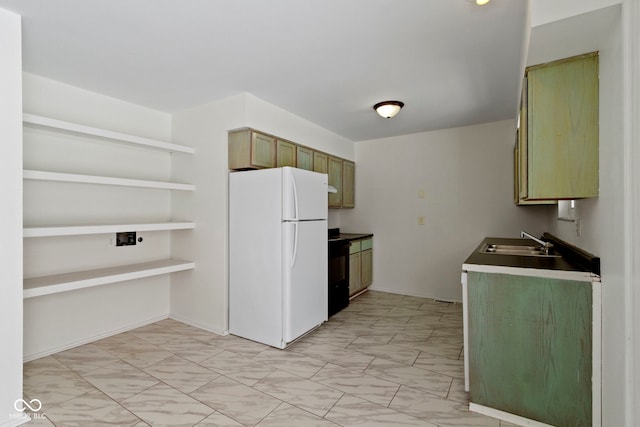 kitchen featuring marble finish floor, a sink, freestanding refrigerator, and black electric range oven