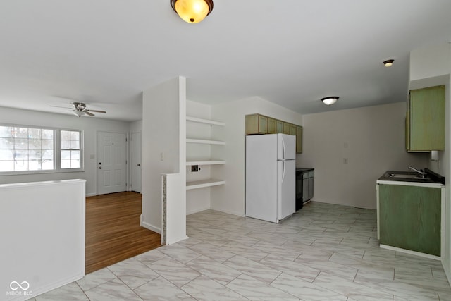 kitchen featuring a ceiling fan, a sink, and freestanding refrigerator