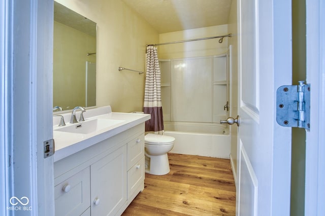 full bathroom with toilet, vanity, shower / bath combination with curtain, and hardwood / wood-style floors