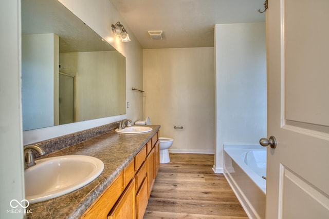 full bathroom featuring toilet, plus walk in shower, hardwood / wood-style floors, and vanity