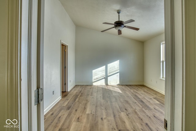 spare room featuring a textured ceiling, ceiling fan, and light hardwood / wood-style flooring