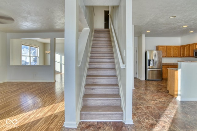 stairs with a chandelier