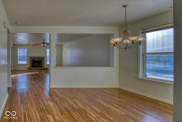 interior space featuring wood-type flooring, a textured ceiling, and an inviting chandelier