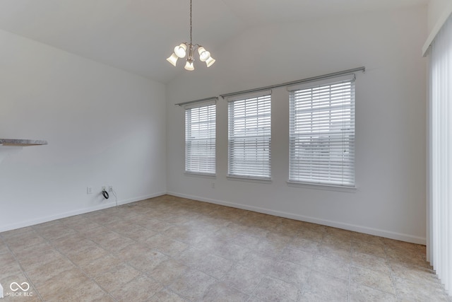 unfurnished room with a healthy amount of sunlight, a chandelier, and lofted ceiling