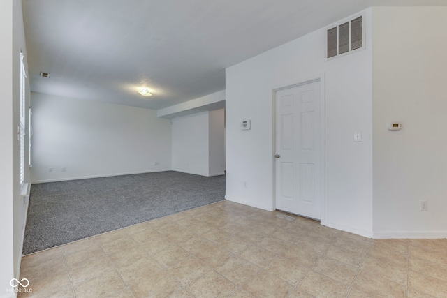 spare room featuring light colored carpet