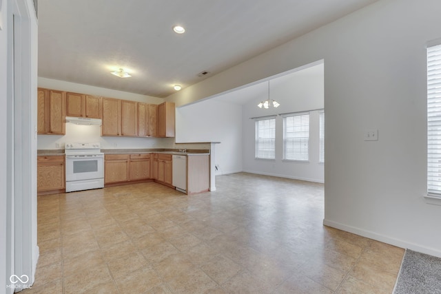 kitchen featuring pendant lighting, white appliances, light brown cabinetry, and an inviting chandelier