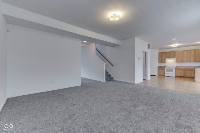 unfurnished living room featuring light colored carpet