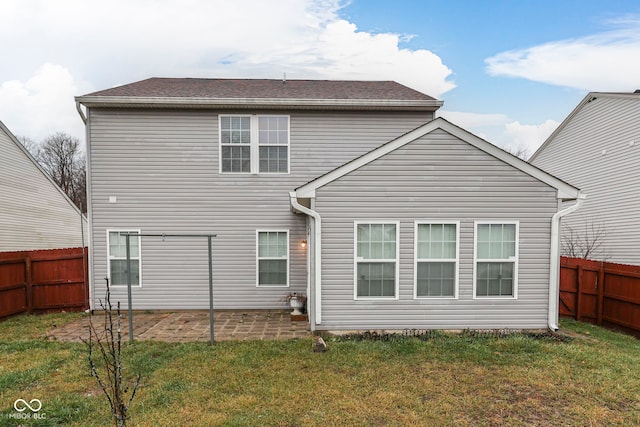 rear view of property with a yard and a patio