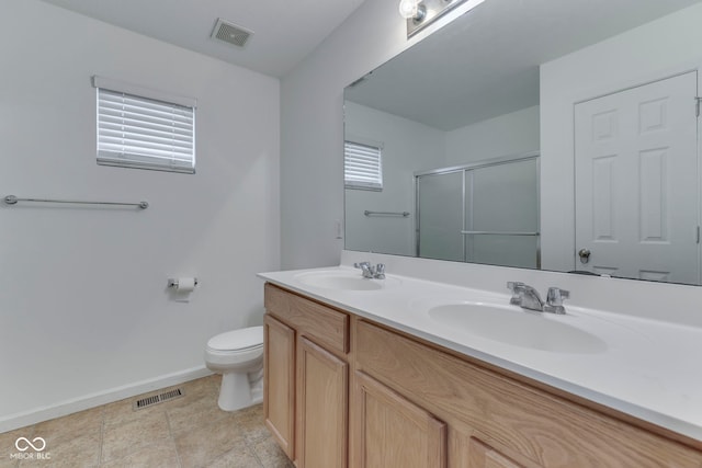 bathroom featuring vanity, toilet, and a shower with shower door