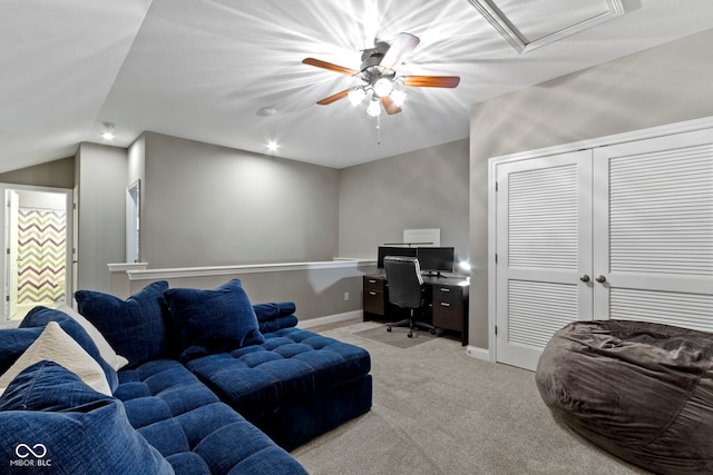 office space with ceiling fan, light colored carpet, and lofted ceiling