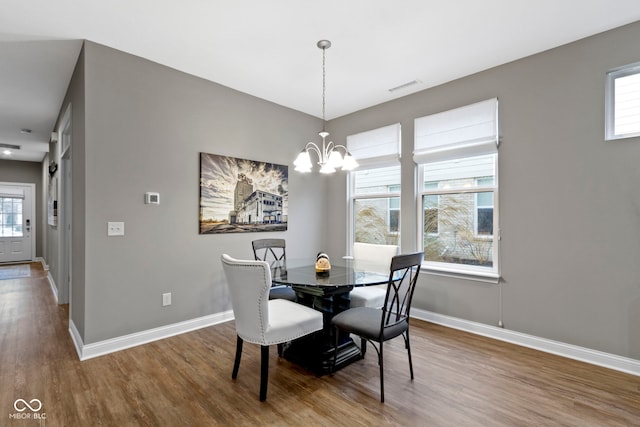 dining space featuring a chandelier and hardwood / wood-style flooring