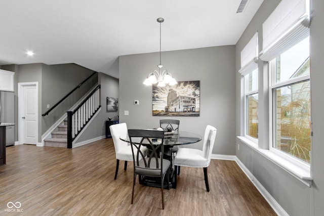 dining room featuring a chandelier and hardwood / wood-style flooring