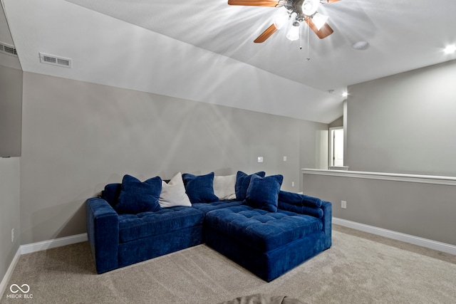 carpeted living room featuring ceiling fan and vaulted ceiling