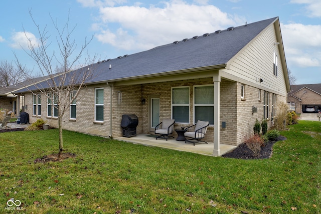 back of property featuring a patio area and a yard