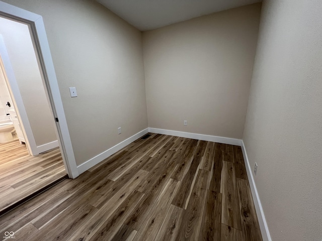 empty room with wood-type flooring