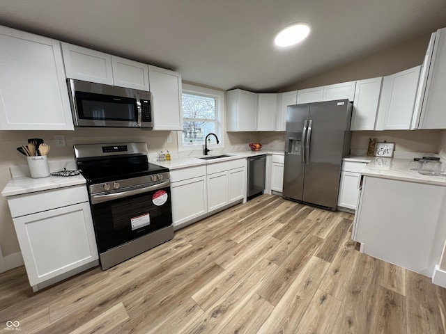 kitchen featuring white cabinets, sink, and appliances with stainless steel finishes