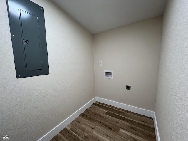 clothes washing area with hookup for an electric dryer, washer hookup, electric panel, and dark hardwood / wood-style floors