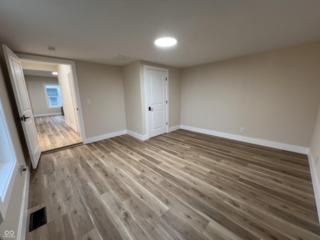 unfurnished bedroom with hardwood / wood-style floors