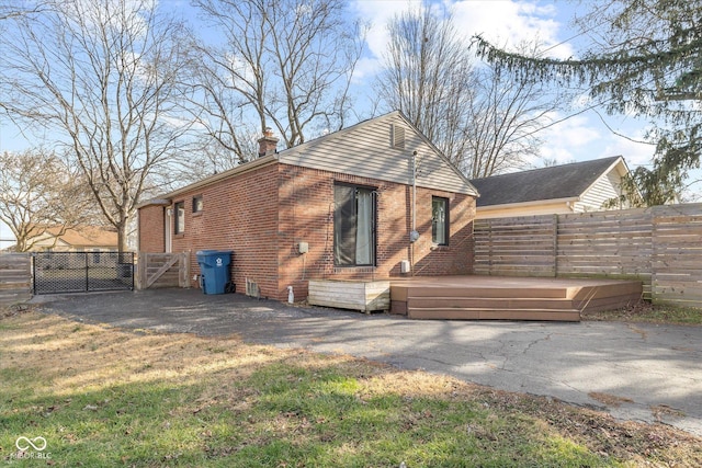 back of property featuring a wooden deck