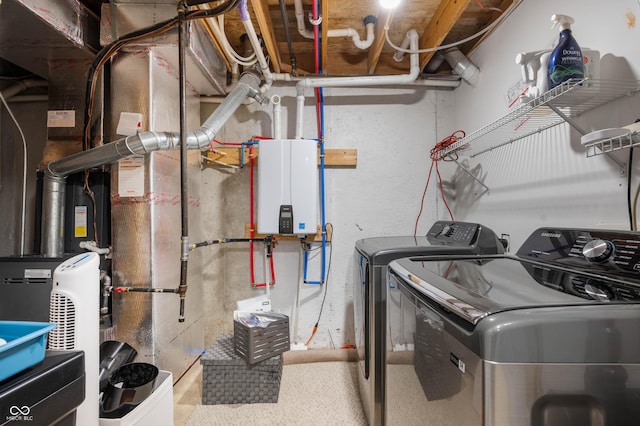 laundry room with water heater and washer and clothes dryer