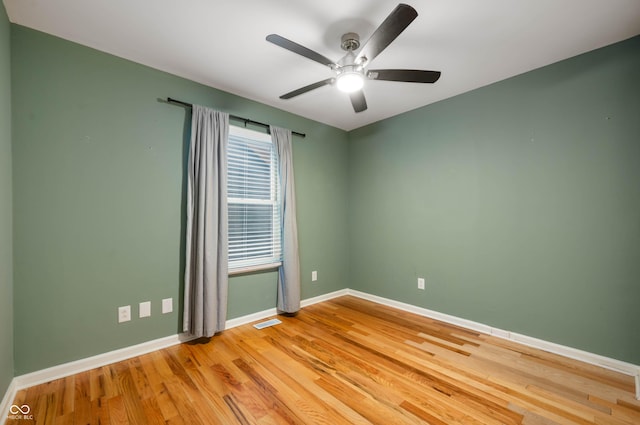 empty room featuring hardwood / wood-style flooring and ceiling fan