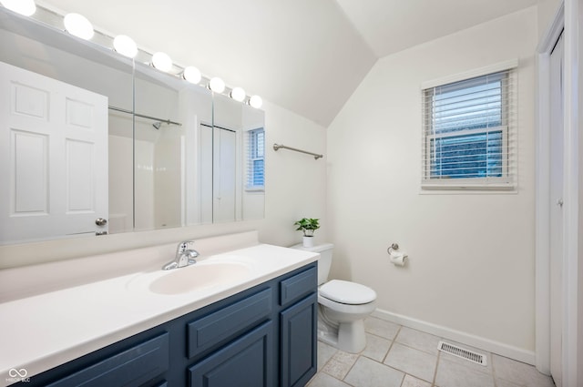 bathroom featuring vanity, a shower, tile patterned flooring, toilet, and lofted ceiling