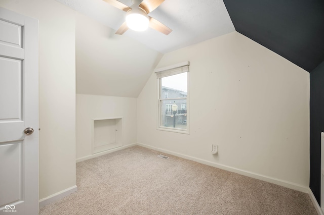 additional living space with ceiling fan, lofted ceiling, and light carpet