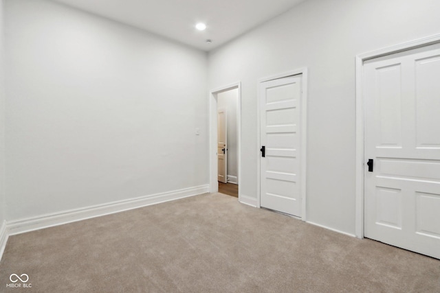 unfurnished bedroom featuring light carpet