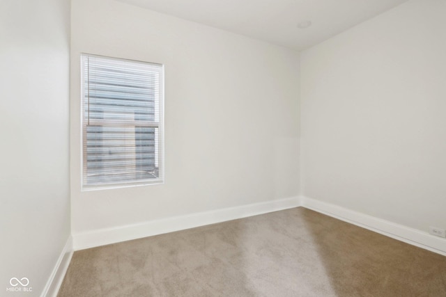 unfurnished room featuring light carpet