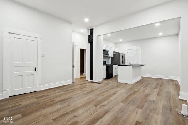 unfurnished living room with light hardwood / wood-style flooring