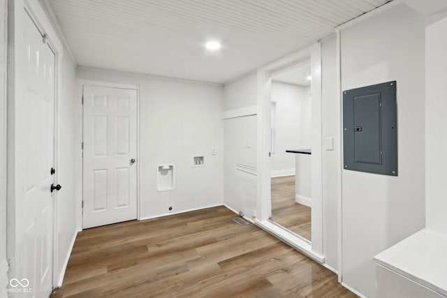 laundry area with hookup for a washing machine, wood-type flooring, and electric panel