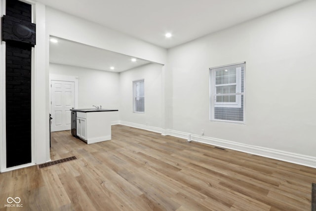 interior space with light wood-type flooring and sink