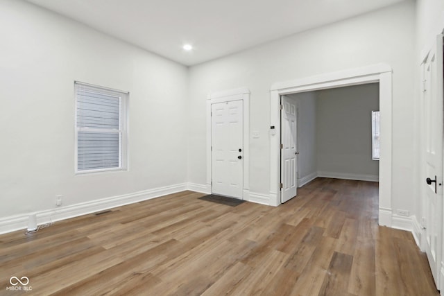 spare room featuring wood-type flooring