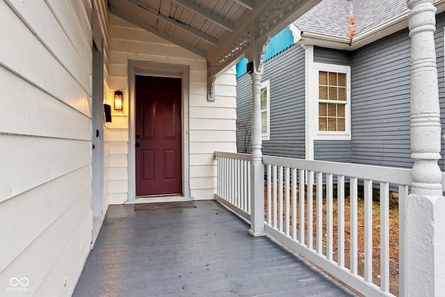 property entrance with roof with shingles and covered porch