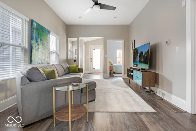 living room with ceiling fan and dark hardwood / wood-style flooring