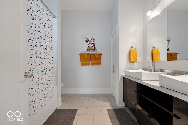 bathroom featuring toilet, vanity, and tile patterned floors